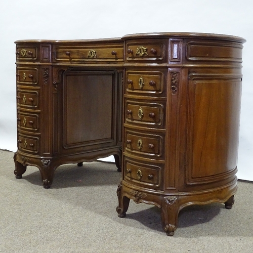 316 - A walnut kidney-shaped pedestal desk, mid-20th century, with shaped moulded panelled drawer fronts a... 