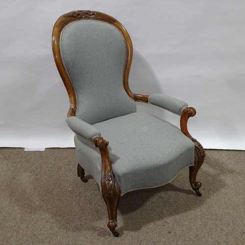 331 - A Victorian walnut-framed open-arm fireside chair