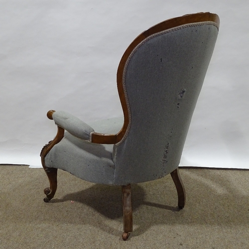 331 - A Victorian walnut-framed open-arm fireside chair