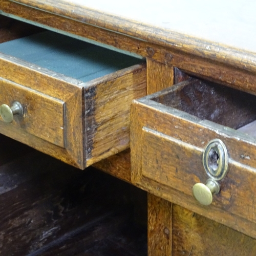 370 - An 18th century oak dresser base, with fielded panelled cupboards and frieze drawers, length 146cm, ... 