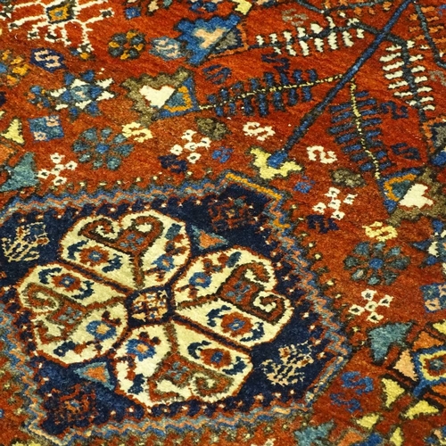 378 - A handmade Abadeh floral decorated rug, 207cm x 158cm.