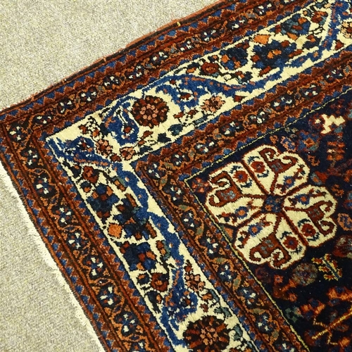 378 - A handmade Abadeh floral decorated rug, 207cm x 158cm.