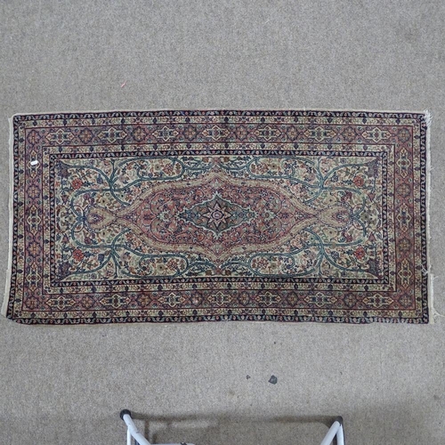 379 - A pink ground Persian rug with intricate pattern, 154 x 82cm.