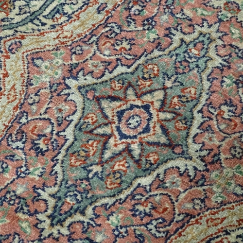 379 - A pink ground Persian rug with intricate pattern, 154 x 82cm.