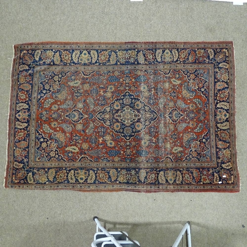 380 - An intricate antique red ground Persian rug, 200 x 135cm.