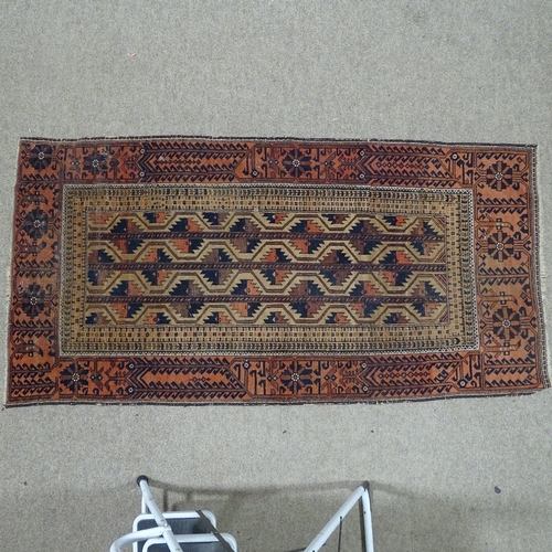 381 - An antique red and brown ground Tekke design wool rug 192 x 97cm