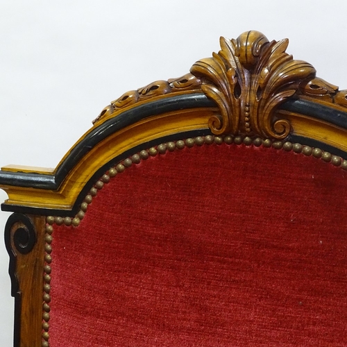 392 - A pair of 19th century walnut and ebonised library armchairs, with acanthus carved arched backs