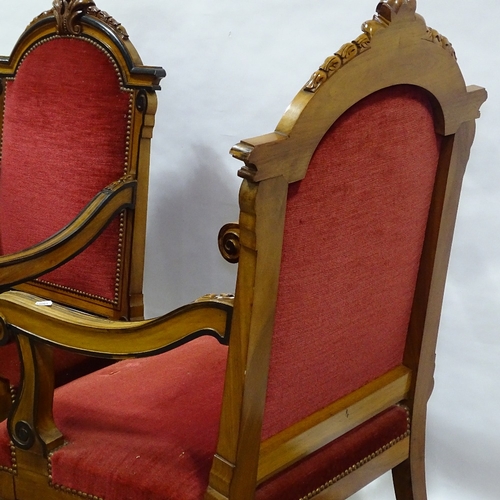 392 - A pair of 19th century walnut and ebonised library armchairs, with acanthus carved arched backs