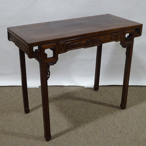 82 - A 19th century Chinese hardwood altar table with relief carved frieze, central frieze drawer raised ... 