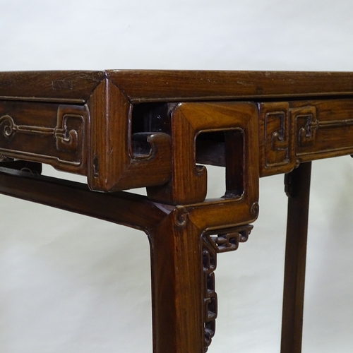 82 - A 19th century Chinese hardwood altar table with relief carved frieze, central frieze drawer raised ... 