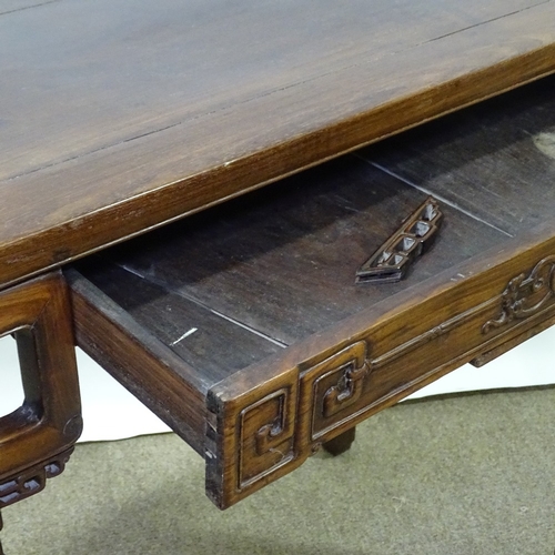 82 - A 19th century Chinese hardwood altar table with relief carved frieze, central frieze drawer raised ... 