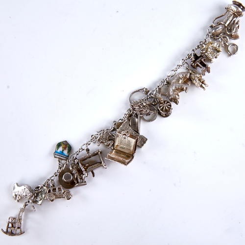 1667 - A Vintage sterling silver charm bracelet, infinity links with 23 charms, bracelet length 19cm, 71.1g