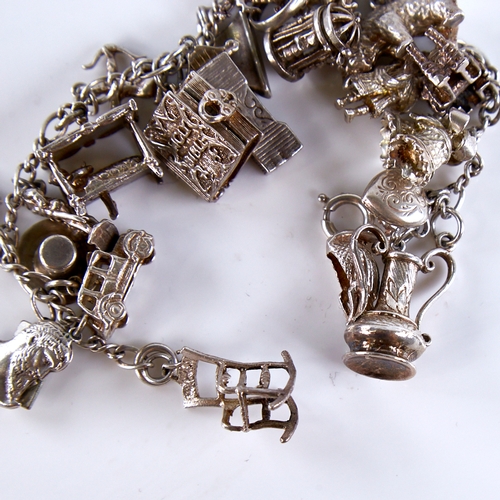 1667 - A Vintage sterling silver charm bracelet, infinity links with 23 charms, bracelet length 19cm, 71.1g