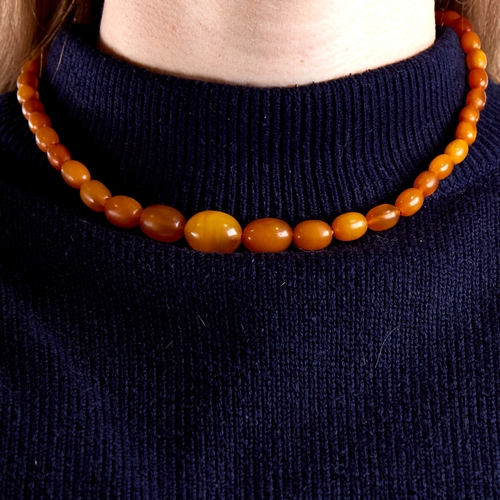 1668 - A Vintage single-strand polished butterscotch amber bead necklace, beads ranging from 17.1mm to 7.5m... 