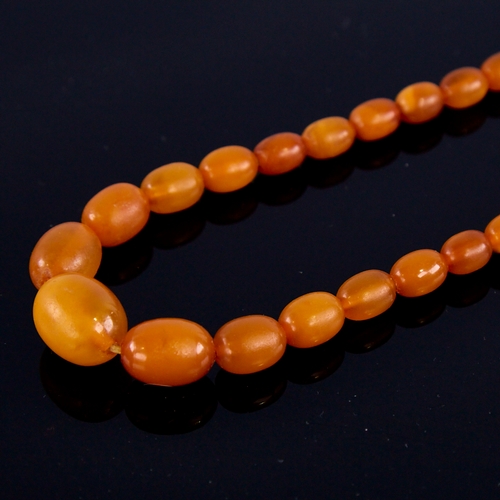 1668 - A Vintage single-strand polished butterscotch amber bead necklace, beads ranging from 17.1mm to 7.5m... 