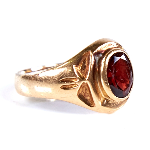 1672 - An 18ct gold garnet signet ring, set with oval mixed-cut garnet with decorated shoulders, setting he... 