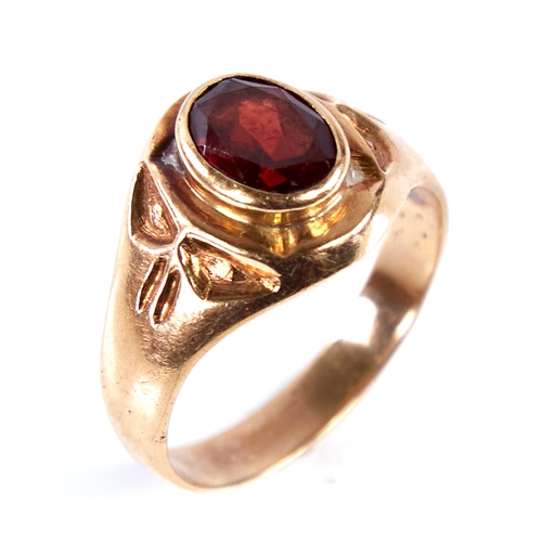 1672 - An 18ct gold garnet signet ring, set with oval mixed-cut garnet with decorated shoulders, setting he... 