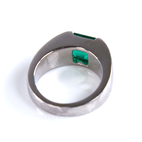 1677 - A Colombian emerald ring, rectangular emerald-cut emerald weighing approx 2.42ct bezel-set in heavy ... 