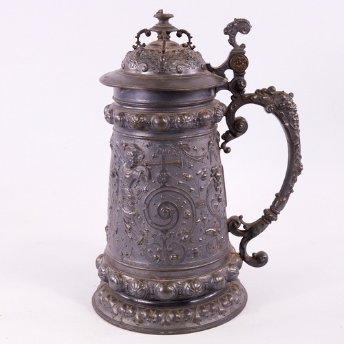 123 - A large Victorian pewter presentation lidded tankard, with relief decorated figures and inscription,... 