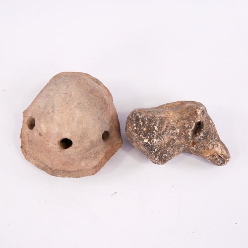 383 - An Ancient terracotta ocarina fragment with mask decoration, length 13cm, and a carved stone animal ... 