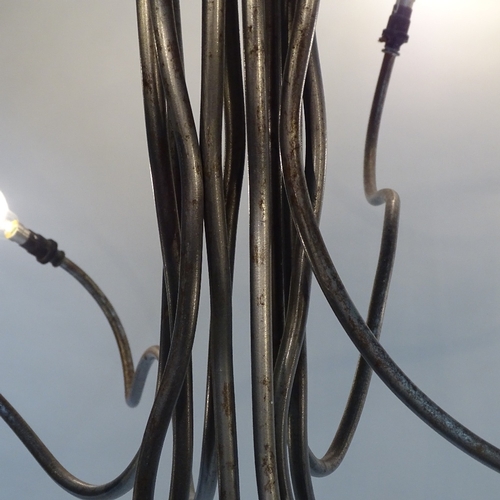 2048 - A 1980s' 10 branch chandelier, in the manner of RON ARAD, an abstract form constructed of raw steel ... 