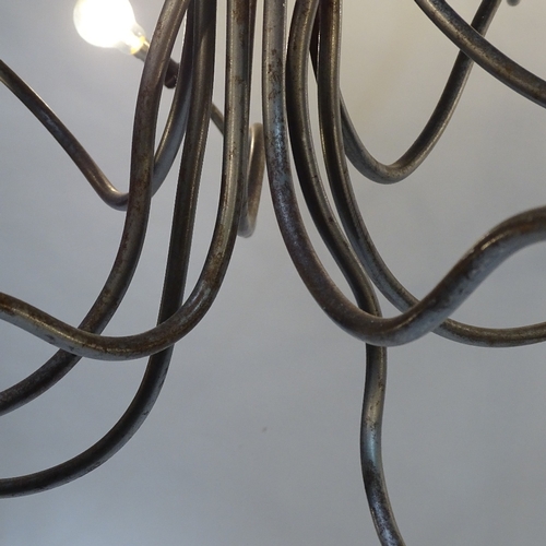 2048 - A 1980s' 10 branch chandelier, in the manner of RON ARAD, an abstract form constructed of raw steel ... 