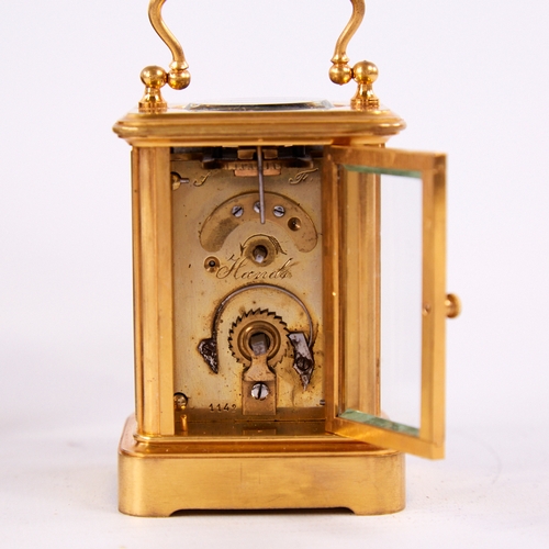 1055 - A 19th century miniature brass-cased carriage clock timepiece, white enamel dial with Roman numeral ... 