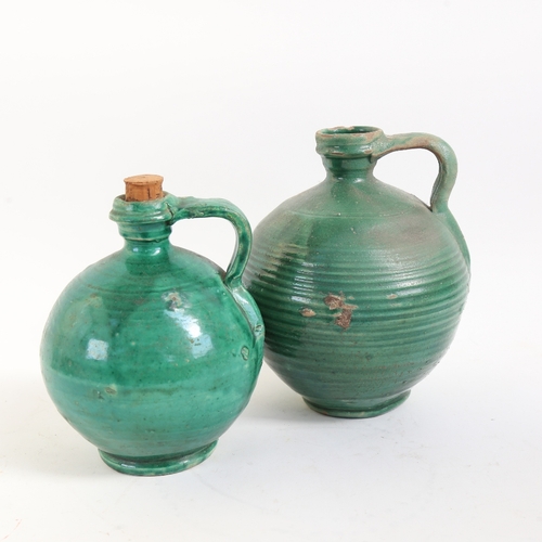 56 - 2 Continental green glaze pottery wine flagons, largest height 20cm (2)