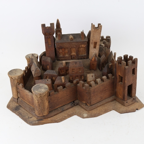 104 - A carved and stained wood hilltop town and castle display, possibly of St Michael's Mount, base leng... 