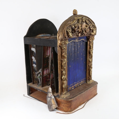 107 - A 19th / early 20th century child's toy puppet theatre, with gilded surround, painted wood sliding c... 