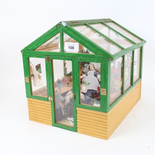 108 - A handmade garden greenhouse diorama, with various fittings, length 32cm, height 28cm