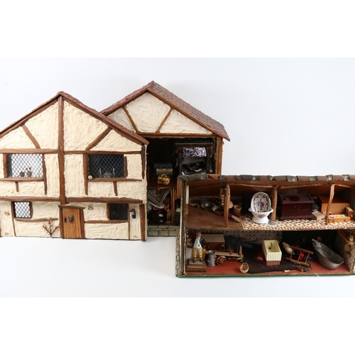 114 - A handmade model doll's house diorama, with many fixtures and fittings, H42cm, W47cm