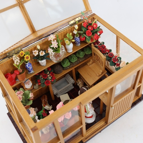 122 - A small doll's house greenhouse with flowers and fittings, W23cm, H20cm, D13cm