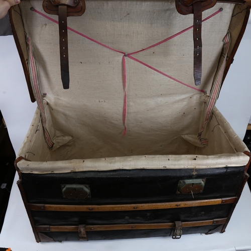 139 - A large early 20th century leather and wood-bound wicker travelling steamer trunk, with cloth lining... 