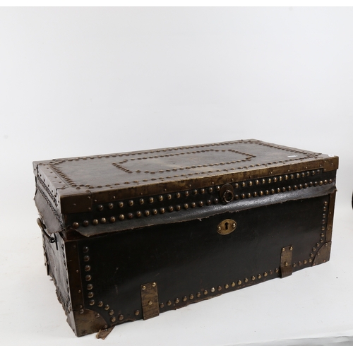 141 - An early 20th century brass-studded leather-bound wood travelling trunk, width 62cm, height 26cm, de... 