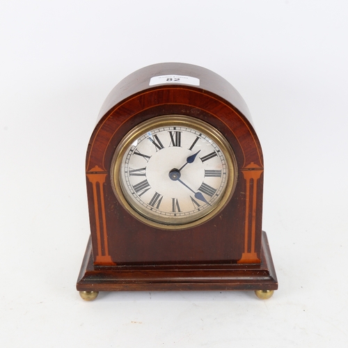 82 - A lacquered and inlaid mahogany dome-top mantel clock, printed dial with Roman numeral hour markers,... 