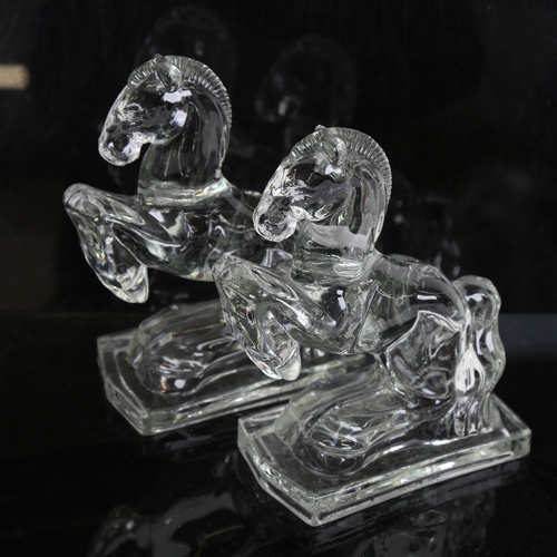 85 - A pair of clear moulded glass rearing horse bookend figures, height 20cm