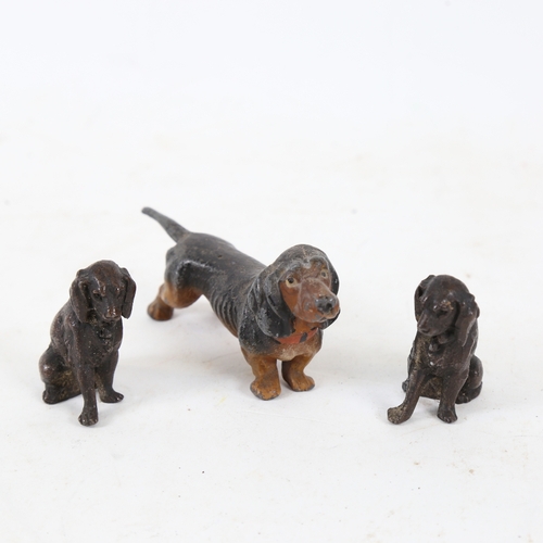 185 - A cold painted spelter Dachshund dog, and a pair of spelter seated Spaniels, Dachshund length 11cm (... 