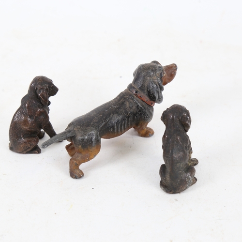 185 - A cold painted spelter Dachshund dog, and a pair of spelter seated Spaniels, Dachshund length 11cm (... 