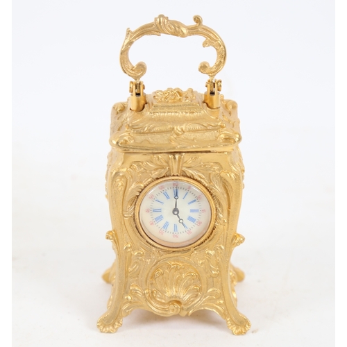 187 - A modern gilt-brass cased miniature carriage clock, relief foliate decoration, with printed dial and... 