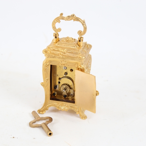 187 - A modern gilt-brass cased miniature carriage clock, relief foliate decoration, with printed dial and... 