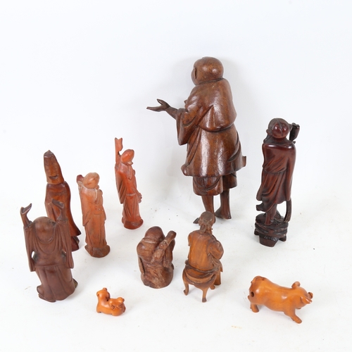 192 - Various Oriental carved wood figures, including pig netsuke, Japanese musician, Shou Lao, largest he... 