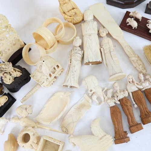 217 - A quantity of various ivory and bone carvings, including lion mask napkin ring, Japanese okimono, Eg... 