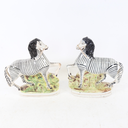 236 - A pair of 19thC Staffordshire zebra figures, height 22cm