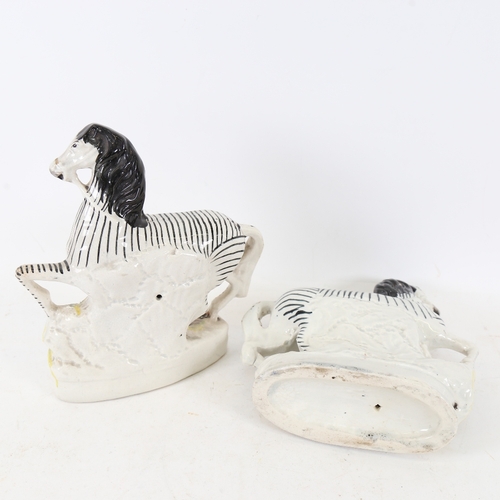 236 - A pair of 19thC Staffordshire zebra figures, height 22cm