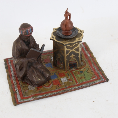 240 - A cold painted metal sculptural desk stand inkwell, in the manner of Bergman, depicting kneeling Ara... 