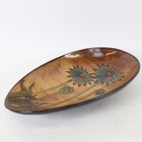 243 - A Chelsea Pottery Art Nouveau style dish, indistinctly signed SW, length 27.5cm, width 17cm