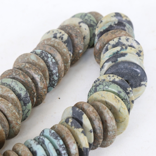 254 - A large carved and polished turquoise matrix disc bead necklace, disc diameter 4.5cm