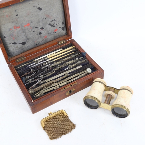 258 - An early 20th century drafting set, bone-mounted opera glasses, and a gilt-metal evening purse (3)