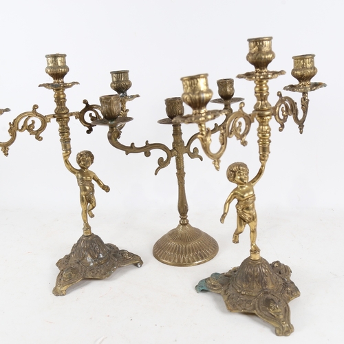 309 - A pair of gilt metal figural 2-branch candlesticks and another, height 35cm (3)